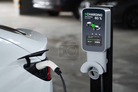 Photo for EV electric car recharge at shopping center parking lot charging in downtown city showing urban sustainability lifestyle by green clean rechargeable energy of electric vehicle innards - Royalty Free Image