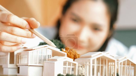 Photo for Closeup of young beautiful architect engineer measure house by using pencil. Interior designer pointing pencil to design house structure. Business design concept. Blurring background. Manipulator. - Royalty Free Image