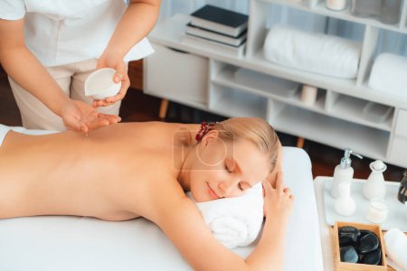 Photo for Masseur hands pouring aroma oil on woman back. Masseuse prepare oil massage procedure for customer at spa salon in luxury resort. Aroma oil body massage therapy concept. Quiescent - Royalty Free Image