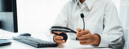 Photo for Business people wearing headset working in office to support remote customer or colleague. Call center, telemarketing, customer support agent provide service on telephone video conference oratory call - Royalty Free Image