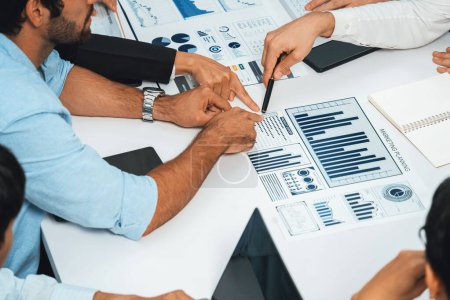 Photo for Analyst team utilizing BI Fintech to analyze financial data at table in meeting room. Businesspeople analyzing BI dashboard power on paper for business insight and strategic marketing planning.Prudent - Royalty Free Image
