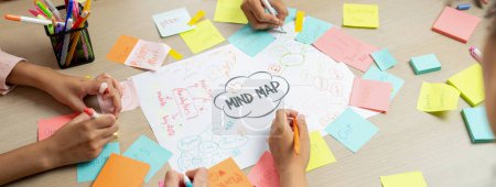 Photo for Professional startup group share creative marketing idea by using mind map. Young skilled business people brainstorm business plan while writing sticky notes. Focus on hand. Closeup. Variegated. - Royalty Free Image