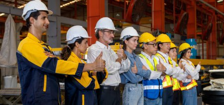 Photo for Confident and smiling lineup of factory worker, engineer, manager and foreman stand on-site within heavy industrial manufacturing factory with sense of teamwork and determination Panorama Exemplifying - Royalty Free Image