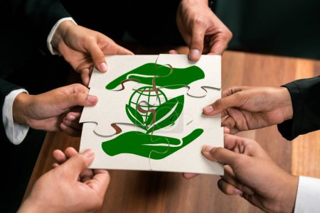 Photo for Cohesive group of business people forming jigsaw puzzle pieces in environmental awareness symbol as eco corporate responsibility for community and sustainable solution for greener Earth. Quaint - Royalty Free Image