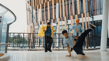 Photo for Hip hop team dance break dance while multicultural friend surrounded and clapping hands to cheer or encourage his friend to dance. Active and energetic street dance. Outdoor sport 2024. Endeavor. - Royalty Free Image