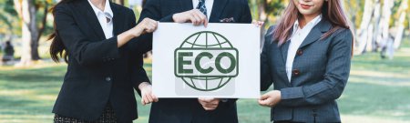 Photo for Group of business people stand united, holding eco-friendly idea and concept for environmental awareness campaign embracing eco friendly and greener environment with inspire positive change.Gyre - Royalty Free Image