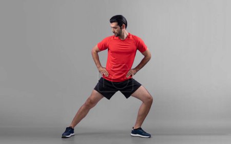 Photo for Full body length gaiety shot athletic and sporty young man with fitness warmup and stretching body for pre exercise posture on isolated background. Healthy active and body care lifestyle. - Royalty Free Image
