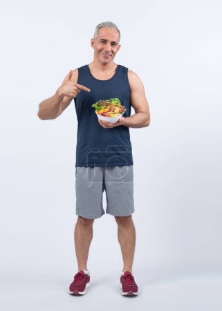 Photo for Happy smile senior man portrait holding bowl of vegan fruit and vegetable on isolated background. Healthy senior people with healthy vegetarian nutrition and body care lifestyle. Clout - Royalty Free Image