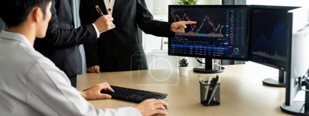 Photo for Group of profession trader discuss about stock market investment while point the increasing financial graph displayed on computer. Stock market investment concept Cropped image. Burgeoning. - Royalty Free Image