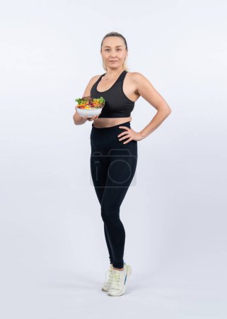 Photo for Happy smile senior woman portrait holding bowl of vegan fruit and vegetable on isolated background. Healthy senior people with healthy vegetarian nutrition and body care lifestyle. Clout - Royalty Free Image