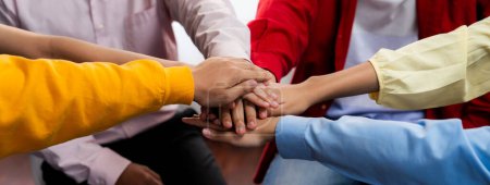 Photo for Startup company employee team stacking hand together symbolize successful group of business partnership and strong collective unity teamwork in community workplace in panoramic banner. Synergic - Royalty Free Image