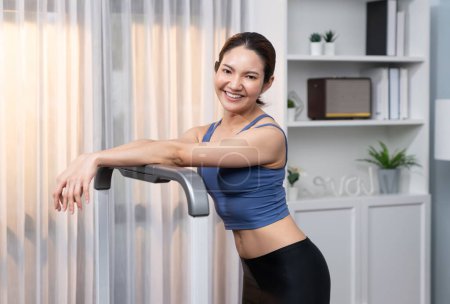 Photo for Asian woman in sportswear portrait, smiling and posing cheerful gesture. Home workout training or exercise fitness lifestyle. Attractive girl engage in her pursuit of healthy lifestyle. Vigorous - Royalty Free Image
