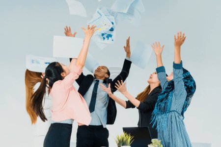 Photo for Smiling business people having fun by throwing papers in the air celebrating business success in the modern office. Happy workplace and casual career company concept. uds - Royalty Free Image