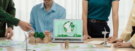 Photo for Green city logo displayed on a laptop at a green business meeting. Team presenting green design to customer. ESG environment social governance and Eco conservative concept. Closeup. Delineation. - Royalty Free Image