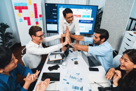 Photo for Happy office worker and project manager celebrate in meeting room after successfully achieving business task on time and on schedule. Project management tracking software for business success. Prudent - Royalty Free Image