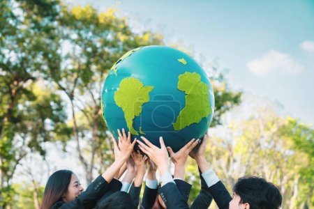 Photo for Earth day concept with big Earth globe held by group of asian business people team promoting environmental awareness to solve global warming with environmentally sustainability and ESG principle. Gyre - Royalty Free Image