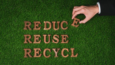 Photo for Environmental awareness campaign showcase arranged by hand recycle message in on biophilic green grass background. Environmental social governance concept idea for sustainable and greener future. Gyre - Royalty Free Image
