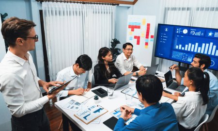 Photo for Analyst team utilizing BI Fintech to analyze financial data at table in meeting room. Businesspeople analyzing BI dashboard power for business insight and strategic marketing planning. Prudent - Royalty Free Image