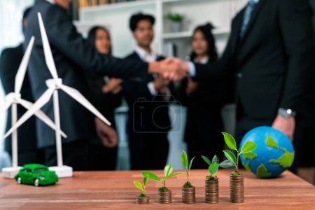 Photo for Organic money growth investment concept shown by stacking piles of coin with sprout or baby plant on top. Financial investments rooted and cultivating sustainable clean energy with nature. Quaint - Royalty Free Image