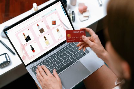 Photo for Woman shopping online on internet marketplace browsing for sale items for modern lifestyle and use credit card for online payment from wallet protected by utmost cyber security software - Royalty Free Image