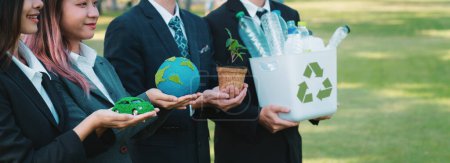 Photo for Group of businesspeople volunteer to promote Earth Day and environmental friendly, embracing ESG or Environmental, Social, and Governance practice to contribute greener environment sustainability.Gyre - Royalty Free Image