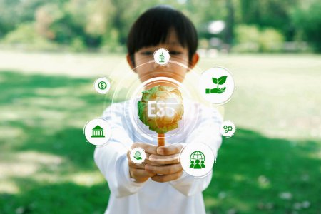 Photo for Little kid nurturing plant with eco icon symbolize natural preservation for future sustainable generation by growing plant to reduce carbon emission and using ESG green technology. Panorama Reliance - Royalty Free Image