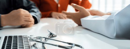 Photo for Couple attend fertility consultation with gynecologist at hospital as part family planning care for pregnancy. Loving husband and wife support each other through the doctor appointment. Panorama Rigid - Royalty Free Image