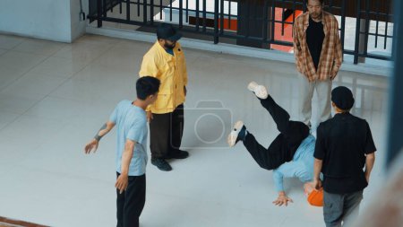 Photo for Top view of skilled hipster perform break dance surrounded by street dancer. Group of multicultural street dancer looking at professional choreographer doing freeze pose. Outdoor sport 2024. Endeavor. - Royalty Free Image