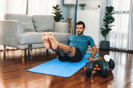 Photo for Athletic and sporty man doing crunch on fitness mat during home body workout exercise session for fit physique and healthy sport lifestyle at home. Gaiety home exercise workout training concept. - Royalty Free Image