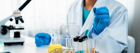 Photo for Laboratory researcher develop new medicine or cure using chemical liquid in lab tube. Technological advance of healthcare with scientific expertise with laboratory equipment. Panorama Rigid - Royalty Free Image