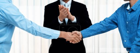 Photo for Corporate attorney applaud as business people seal a successful deal or agreement with handshake, celebrating mutually beneficial acquisition. Business handshaking concept. Panorama Rigid - Royalty Free Image
