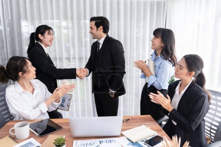 Photo for Group of businesspeople shake hand after made successful business agreement meeting. Diverse race office worker celebrate after made progress on marketing planning in corporate office. Meticulous - Royalty Free Image