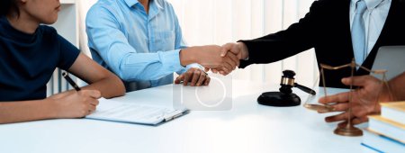Photo for Couple shake hand with their lawyer after successfully completing marriage certification and receiving legal marriage consultation assistance from law firm. Panorama Rigid - Royalty Free Image