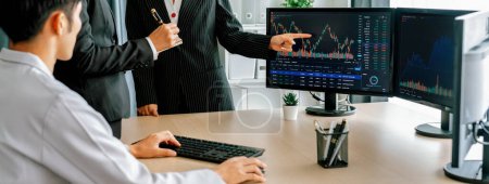 Photo for Group of profession trader discuss about stock market investment while point the increasing financial graph displayed on computer. Stock market investment concept Cropped image. Burgeoning. - Royalty Free Image