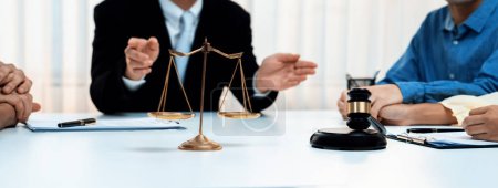 Photo for Focused gavel hammer and balance scale of justice on blurred background of lawyer acting as mediator to broke compromise to resolve legal business dispute with negotiation. Panorama Rigid - Royalty Free Image