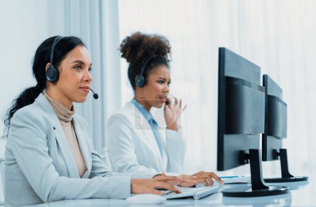 Photo for Business people wearing headset working in office to support remote customer or colleague. Call center, telemarketing, customer support agent provide service on telephone video conference call crucial - Royalty Free Image