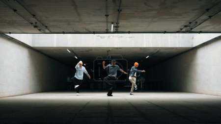 Photo for Panorama shot of hipster group dance together while perform b-boy dance. Street dancer team moving to hip hop music while doing freeze pose. Break dance, street dance. Outdoor sport 2024. Sprightly. - Royalty Free Image