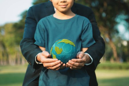 Photo for Asian boy and businessman holding planet Earth together as Earth day concept as corporate social responsible to make greener environmental protection for sustainable future generation. Gyre - Royalty Free Image