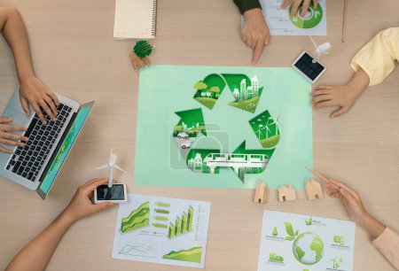 Photo for Eco city and recycle illustration placed on a meeting table during a green business meeting discussion. ESG environment social governance and Eco conservative concept. Top view. Delineation. - Royalty Free Image