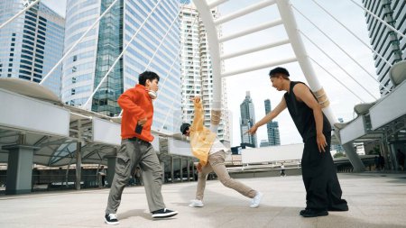 Photo for Group of professional happy street dancer cheer up while asian hipster perform b boy dance at urban city surrounded by people with low angle camera. Break dance concept. Outdoor sport 2024. Sprightly. - Royalty Free Image