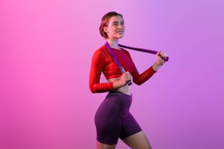 Photo for Full body length gaiety shot athletic and sporty young woman with fitness elastic resistance band in standing posture on isolated background. Healthy active and body care lifestyle. - Royalty Free Image