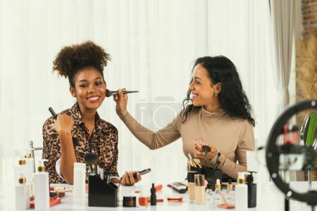 Photo for Woman influencer shoot live streaming vlog video review makeup crucial social media or blog. Happy young girl with cosmetics studio lighting for marketing recording session broadcasting online. - Royalty Free Image