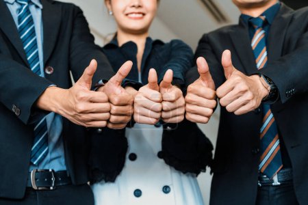 Photo for Many happy business people make thumbs up sign join hands together with joy and success. Company employee celebrate after successful work project. Corporate partnership and achievement concept. uds - Royalty Free Image