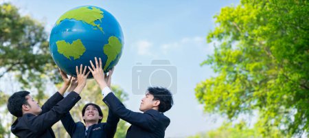 Photo for Earth day concept with big Earth globe held by group of asian business people team promoting environmental awareness with environmentally sustainability and ESG principle for brighter future. Gyre - Royalty Free Image