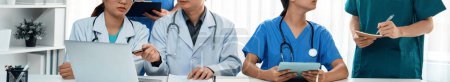 Photo for Professional various team of medical working and planning medical treatment at hospital table together. Teamwork lead to successful illness and sickness treatment. Panorama Rigid - Royalty Free Image
