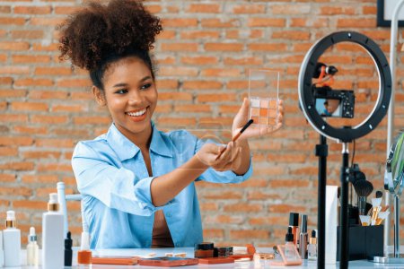 Photo for Woman influencer shoot live streaming vlog video review makeup crucial social media or blog. Happy young girl with cosmetics studio lighting for marketing recording session broadcasting online. - Royalty Free Image