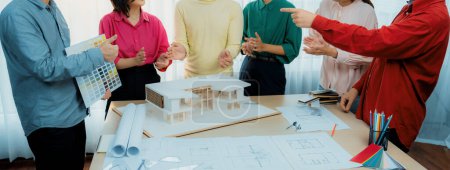 Photo for Professional interior designer team clapping hand to celebrate their successful project while project manager presents their main theme color. Creative design and teamwork concept. Variegated. - Royalty Free Image