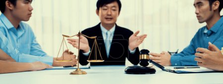 Photo for Focused gavel hammer and balance scale of justice on blurred background of lawyer acting as mediator to broke compromise to resolve legal business dispute with negotiation. Panorama Rigid - Royalty Free Image