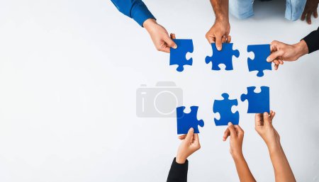 Photo for Top view panorama banner of business team joining jigsaw puzzle together over meeting table symbolize business partnership and collective unity teamwork in problem solving solution. Prudent - Royalty Free Image