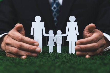 Photo for Background of paper family icon held in hand symbolize dedication to environmental friendly lifestyle of modern family, parenthood guiding sustainable lifestyle to their children. Gyre - Royalty Free Image